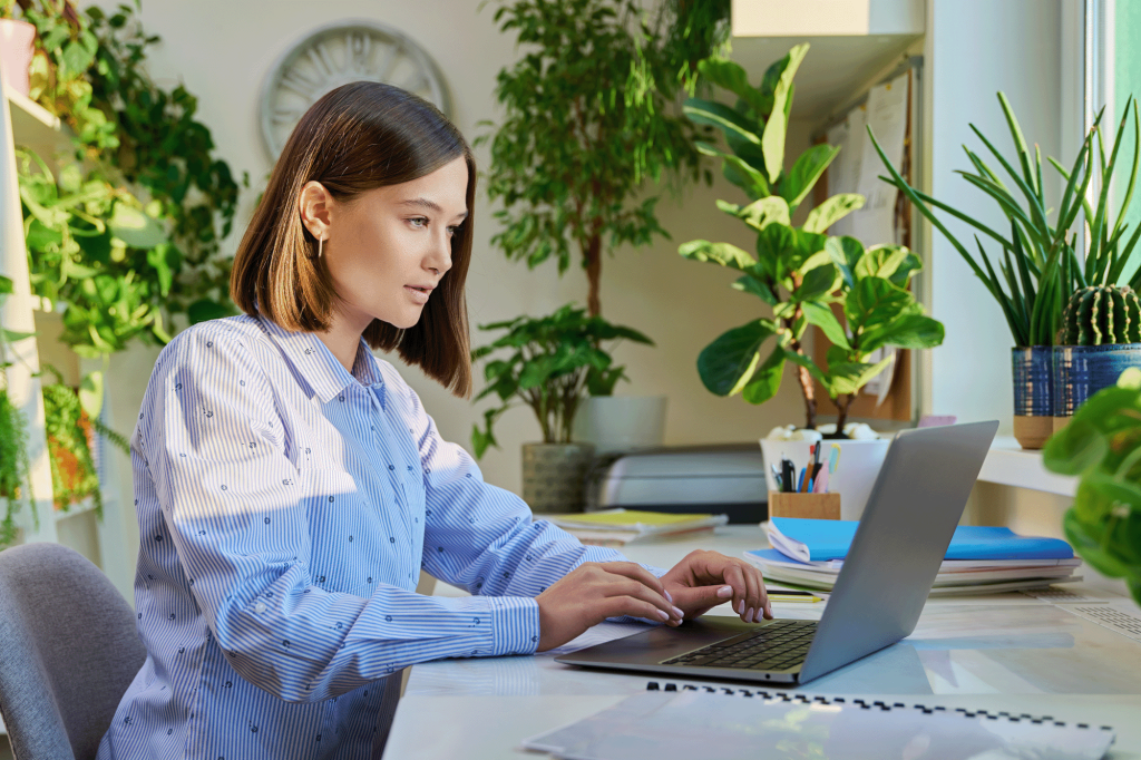 Female copywriter typing on laptop computer